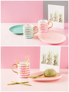 Detail of ceramic mugs with gold handles and baby girl/boy lettering for couples