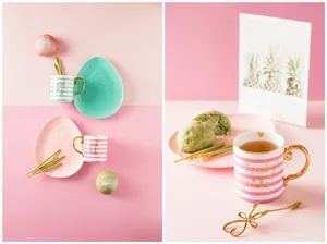 Detail of Nordic ceramic mugs with gold handles, striped patterns, and baby girl lettering