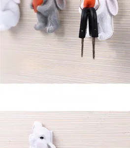 Strong resin adhesive wall hooks with cartoon rabbit design holding keys on a wall