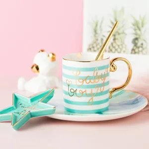 Nordic ceramic mug set with blue stripes and gold Baby Boy lettering for coffee or milk