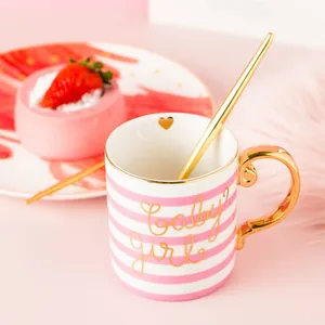 Pink striped ceramic mug with golden handle, baby girl script and heart detail