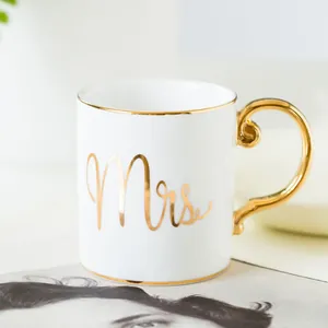 Detail of Mrs. ceramic mug with elegant gold handle and luxury gilded rim accents
