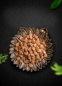 Top view of sunflower shaped bronze resin jewelry tray with nuts as a functional display