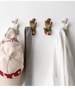 Wall-mounted tree branch hooks set in white and brown with floral rose carvings