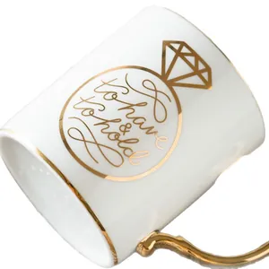 White ceramic diamond ring mug with gold rim and elegant 'to have & to hold' floral text