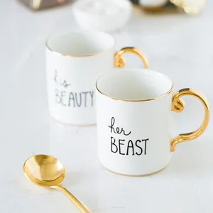 Elegant gold-trimmed ceramic mugs set with his BEAUTY and her BEAST script and spoons