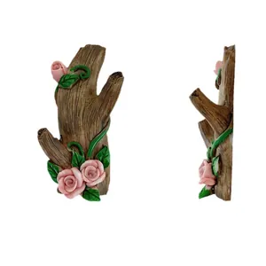 Brown rustic tree branch wall hook with pink resin roses and green leaves decoration