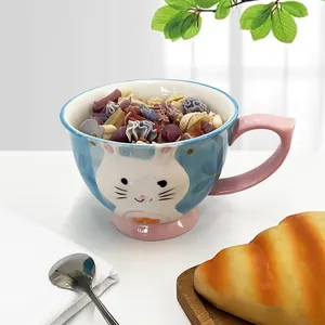 Detail of blue and pink ceramic mug featuring embossed white rabbit and pink wide handle