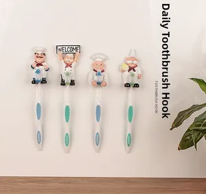 Set of four cute chef wall hooks holding toothbrushes against a clean bathroom background