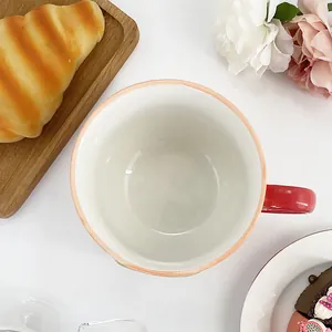 Close-up of ceramic deer mug on a wooden tray with a croissant for breakfast