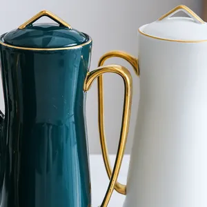 Modern ceramic teapot with gold trim in dark green and white, elegant minimalist design