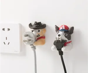 Detail of dog-shaped power plug hooks showing creative golden retriever and terrier design