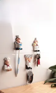 Detail view of four resin chef figurines as wall-mounted multifunctional storage hooks