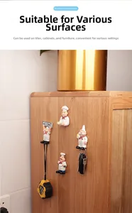 Detail of 4-pack cartoon chef wall hooks holding keys and tools on wooden cabinet