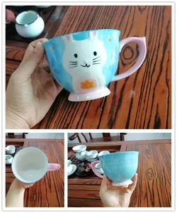 Detail of blue ceramic Easter mug featuring a cute white rabbit and pink handle