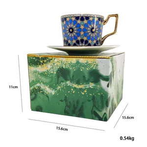 Detail of European ceramic coffee cup set with gold handle and marble pattern gift box