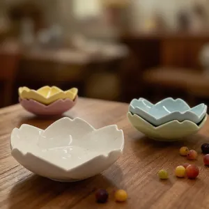 Detail of cherry blossom shaped ceramic seasoning dishes in elegant pastel colors