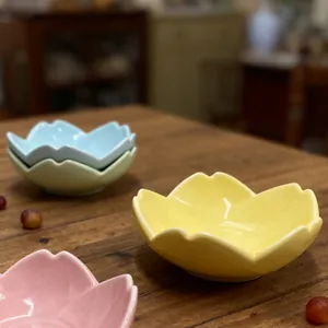 Detailed macro view of cherry blossom shaped ceramic bowls with smooth glossy finish