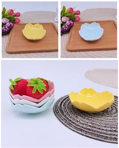 Detail of petal-shaped ceramic dipping bowls in pink, blue, white and yellow colors