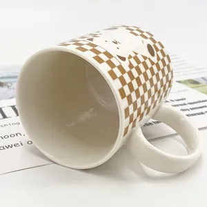 Brown checkerboard ceramic mug with cute cartoon animal face and large handle