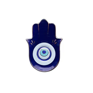 Vassoio per gioielli Hamsa in ceramica con design malocchio e bordo dorato elegante