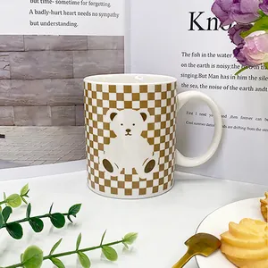 Close-up of ceramic mug featuring retro checkered patterns and cute bear print