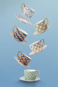 Modern British ceramic coffee cups with geometric patterns and gold geometric handles