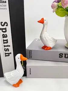 Figurines d'oie modernes en low poly avec facettes géométriques sur des livres