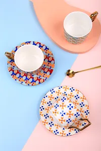 Detailed view of luxury ceramic coffee cup with gold handle and geometric pattern