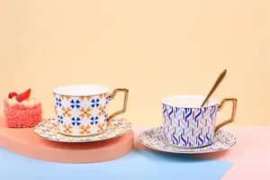 Detail of luxury ceramic coffee cups with geometric patterns and gold handles