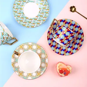 British style ceramic coffee cup and saucer set with gold trim and geometric patterns