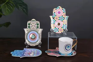 Detail showing colorful Hamsa ceramic plates and mug with intricate Moroccan gold patterns