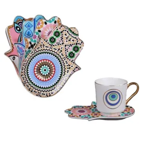 European ceramic coffee cup set with gold handle and Hamsa hand saucer in colorful patterns