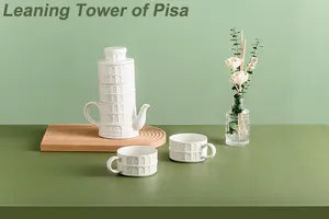 Detailed view of white ceramic Leaning Tower of Pisa tea set on a wooden tray