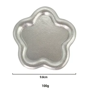 Star-shaped silver metal jewelry tray with textured finish for rings and accessories