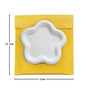 Top-down view of a white flower-shaped resin tray with dimensions 13.5cm by 13cm