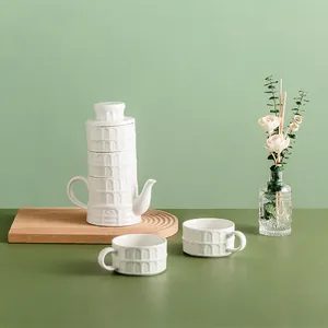 Leaning Tower ceramic tea set with white stacked teapot and two matching embossed mugs
