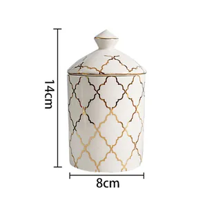 Detailed view of 14cm white ceramic storage jar with gold geometric Moroccan pattern