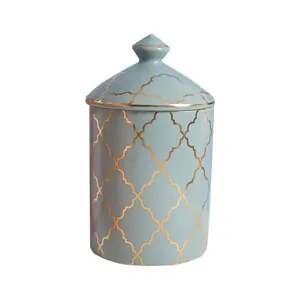 Light blue ceramic storage jar with golden quatrefoil pattern and matching lid