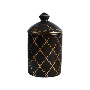 Detail of a ceramic jar with black glaze and golden quatrefoil pattern and lid