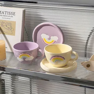 Detail shot of ceramic coffee cups and saucers with 3D rainbow and cloud relief