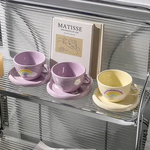 Close-up of ceramic rainbow coffee cup set on Matisse book for a cozy lifestyle feel