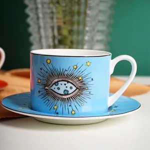 Blue ceramic coffee cup and saucer set with creative star eye patterns and black rim