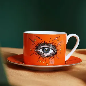 Detailed macro shot of ceramic evil eye coffee cup with gold rim on silk background