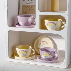 Hand-painted ceramic coffee cup and saucer set with 3D rainbow and flower embossed details
