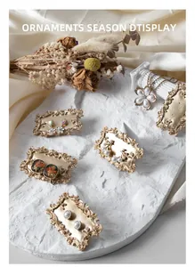 Detail of vintage gold earrings with pearls and crystals on an embossed display frame