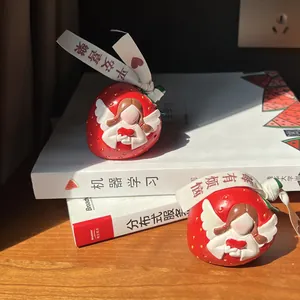 Cute strawberry resin desk ornament featuring a white embossed angel and a red heart