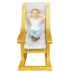 Resin figurine of a man relaxing on a gold rocking chair for dollhouse garden decor