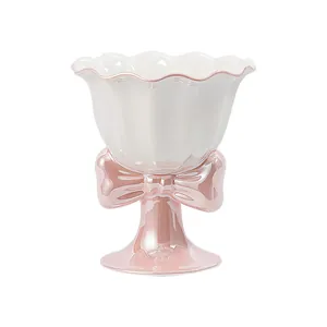 Iridescent ceramic ice cream bowl with wavy rim and pink bow high foot stand