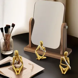Abstract golden thinker figurines used as elegant jewelry organizers for necklaces and bracelets